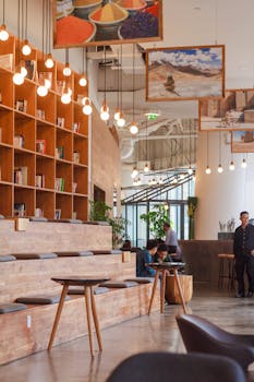 Elegant modern workspace in Ho Chi Minh City with bookshelves and pendant lighting.